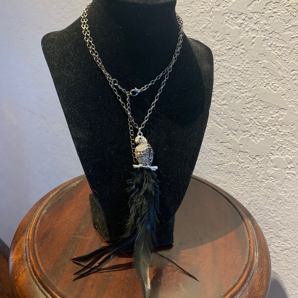 Bird pendant on long chain